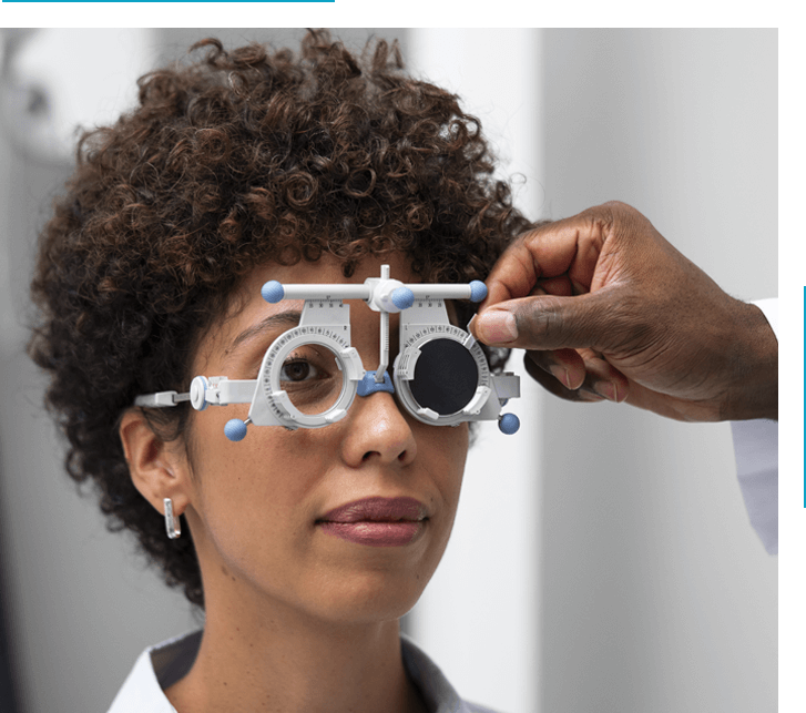 A woman getting her eyes checked by an optometrist.